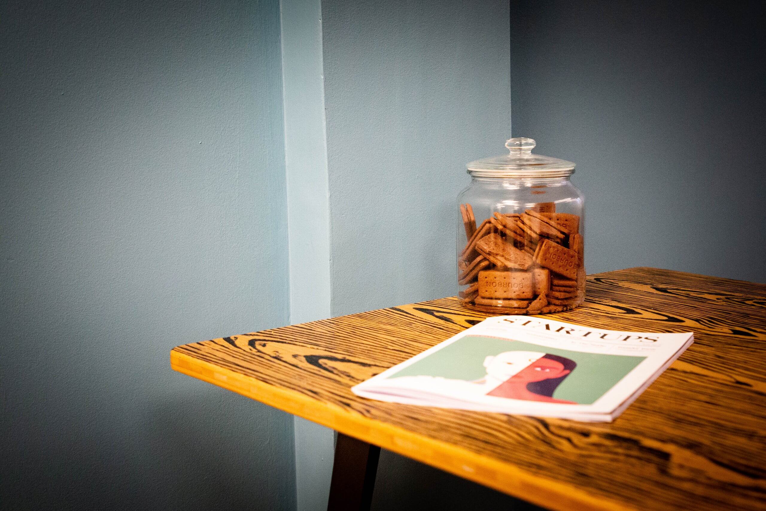 Coffee table with biscuits and a magazine.