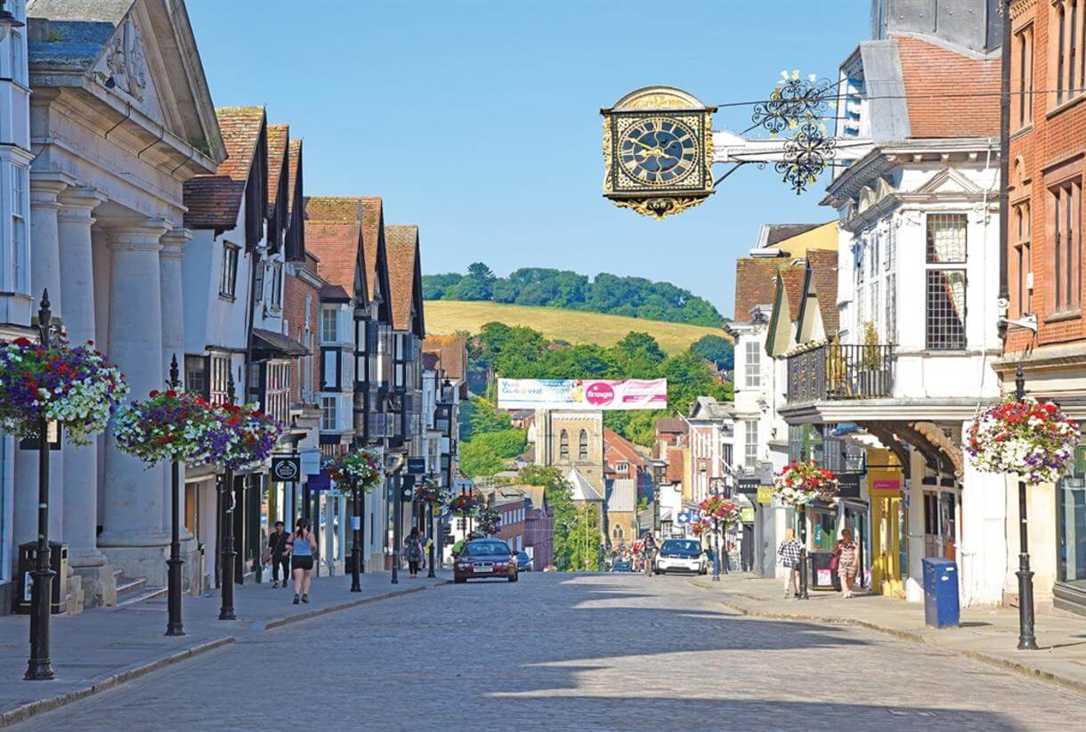 Guildford Highstreet with offices and shops either side of the street.