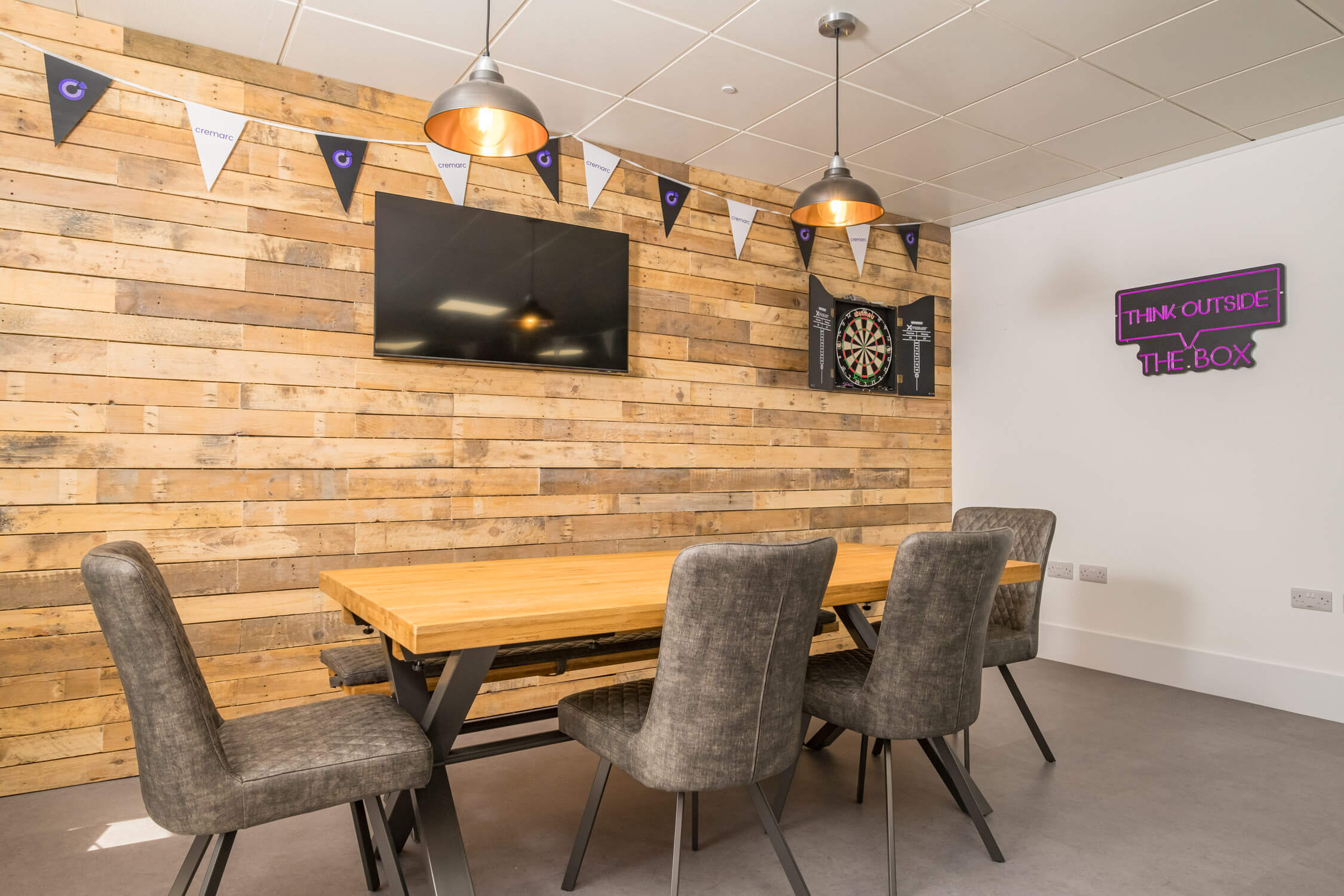 Office featuring a leisure area with a dartboard and TV